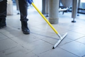 Dry mopping the floor before using floor scrubber.